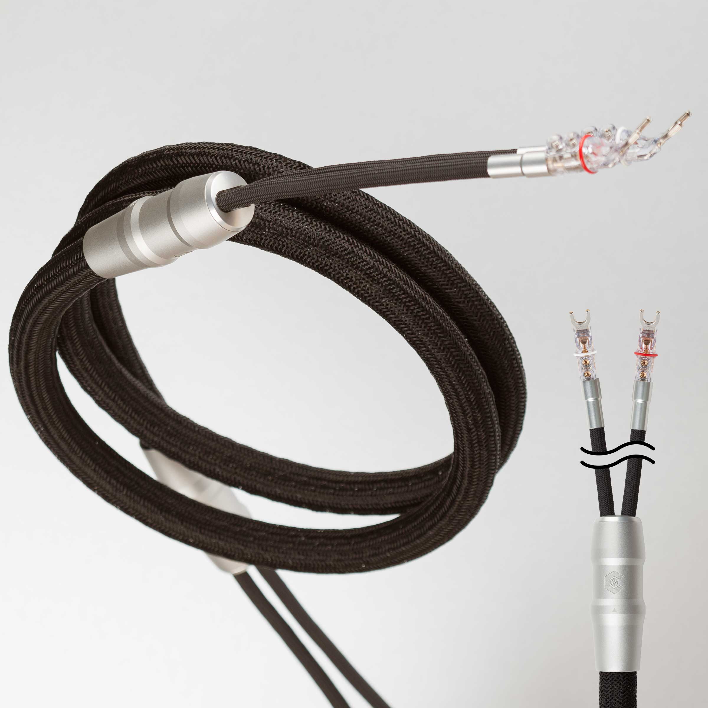 Kimber Kable Carbon series speaker cable, coiled, showing its braided black sheath and machined connectors.